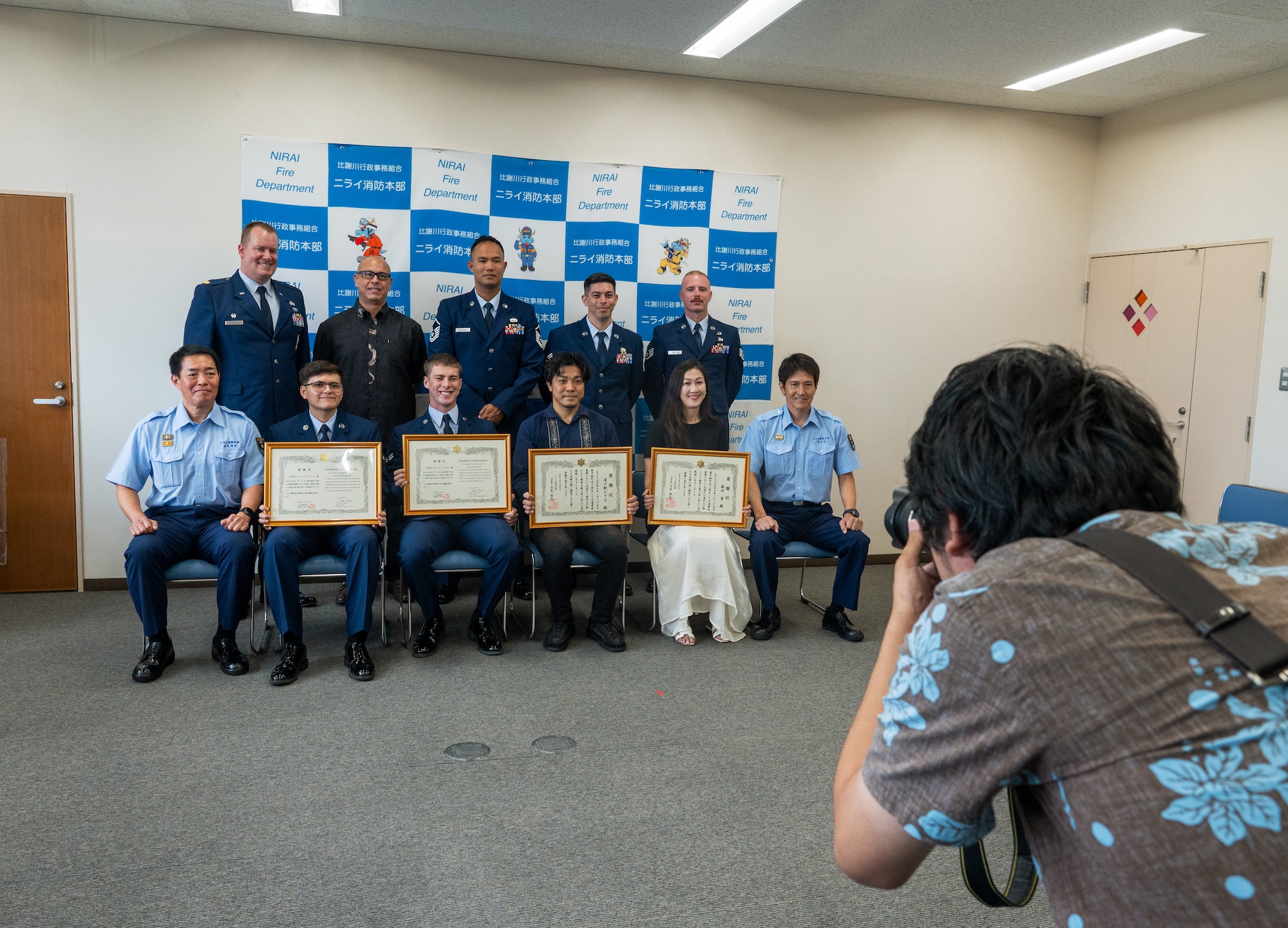 U.S. Air Force personnel and Okinawan local nationals pose for a photo.