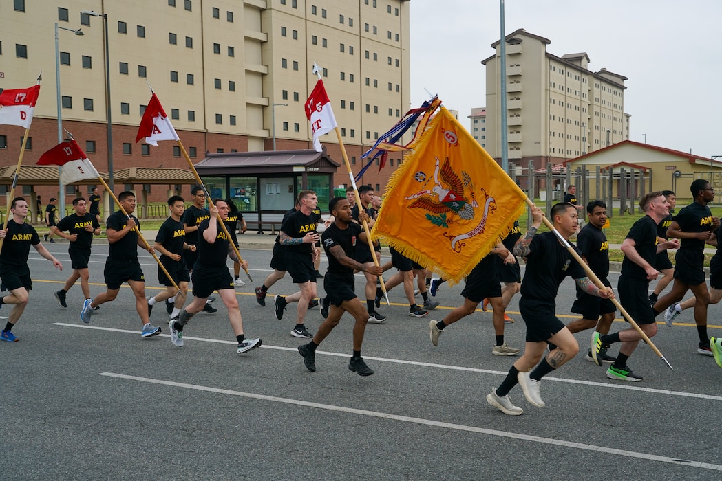 U.S. Army soldiers participating in the Eighth Army Garrison run carry their unit guide-ons to celebrate KATUSA Friendship Week 2025 at Camp Humphreys, South Korea, June 9, 2025.