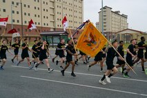 U.S. Army soldiers participating in the Eighth Army Garrison run carry their unit guide-ons to celebrate KATUSA Friendship Week 2025 at Camp Humphreys, South Korea, June 9, 2025.
