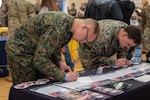 Marine Corps Lance Cpl. Joseph Tanner, left, a communications technician assigned to Marine Aviation Logistics Squadron 26, 2nd Marine Aircraft Wing, and Marine Corps Lance Cpl. Garrett Carrico, a distribution management specialist assigned to 2nd Supply Battalion, 2nd Marine Logistics Group, participate in a SkillBridge event at Marine Corps Base Camp Lejeune, N.C., Jan. 25, 2024.