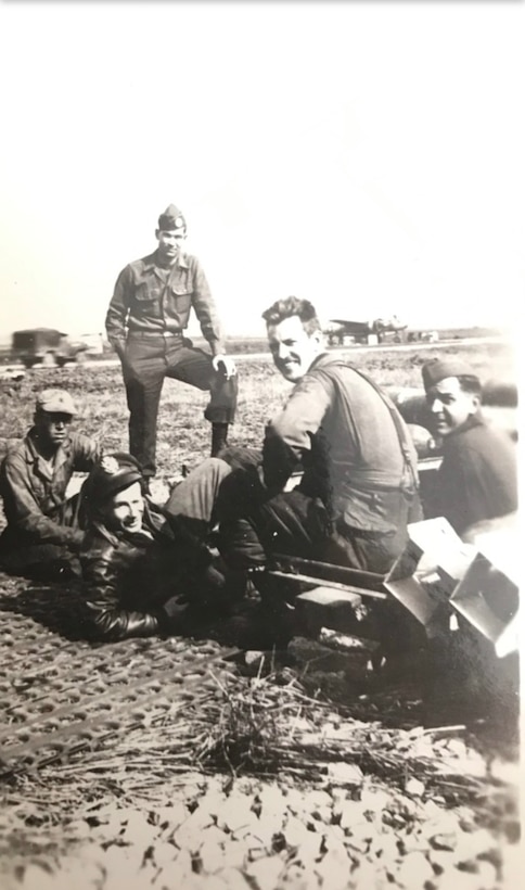 Group of WWII airmen siting together outside