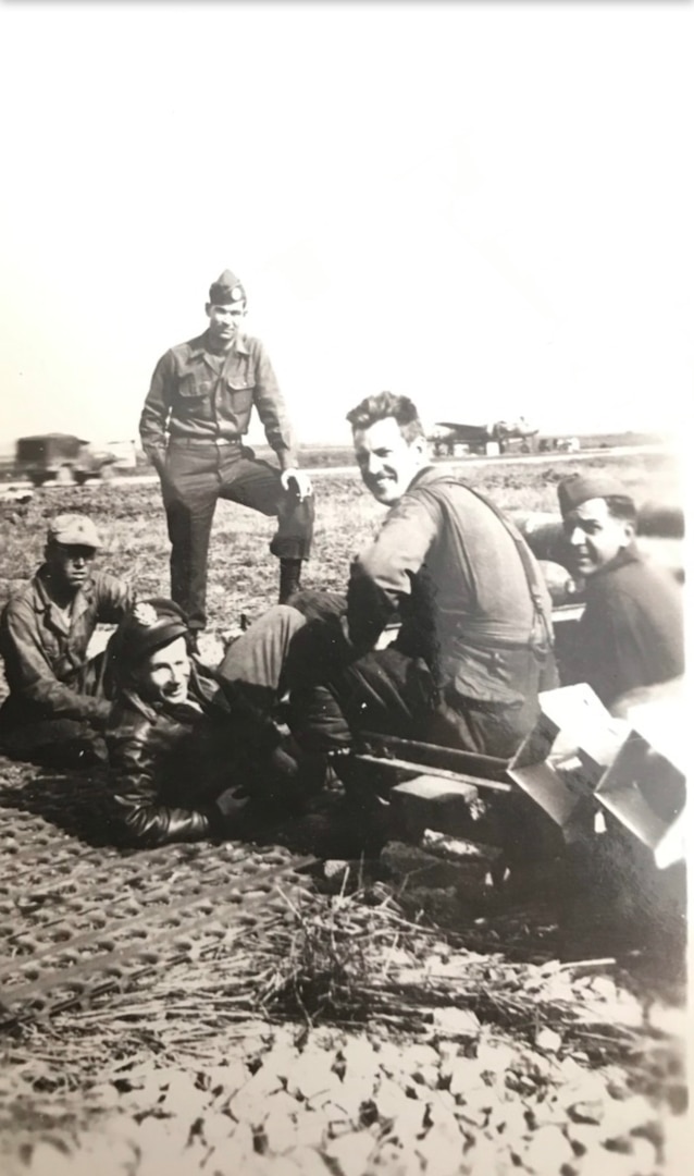 Group of WWII airmen siting together outside