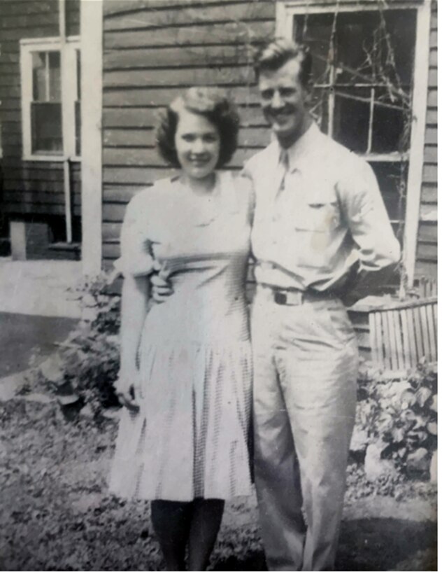 Man and woman standing in front of a house