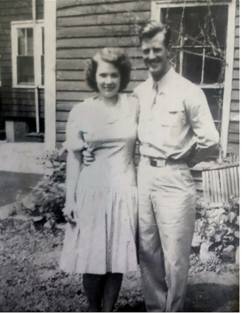 Man and woman standing in front of a house