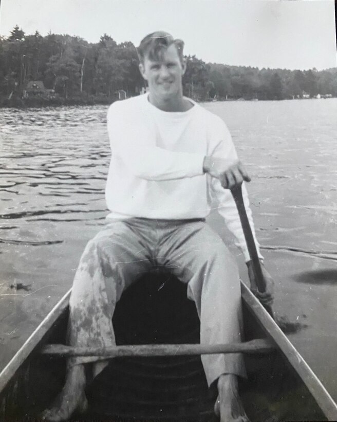 Man paddling in a canoe on the water