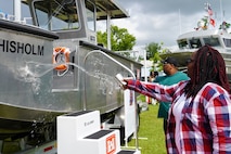 Family members of Sgt. Tyrone Chisholm douse water across the bow of the S/V Chisholm during a dedication ceremony, June 12, 2025, at the U.S. Army Corps of Engineers, Savannah District’s Engineers Depot in Savannah, Georgia.