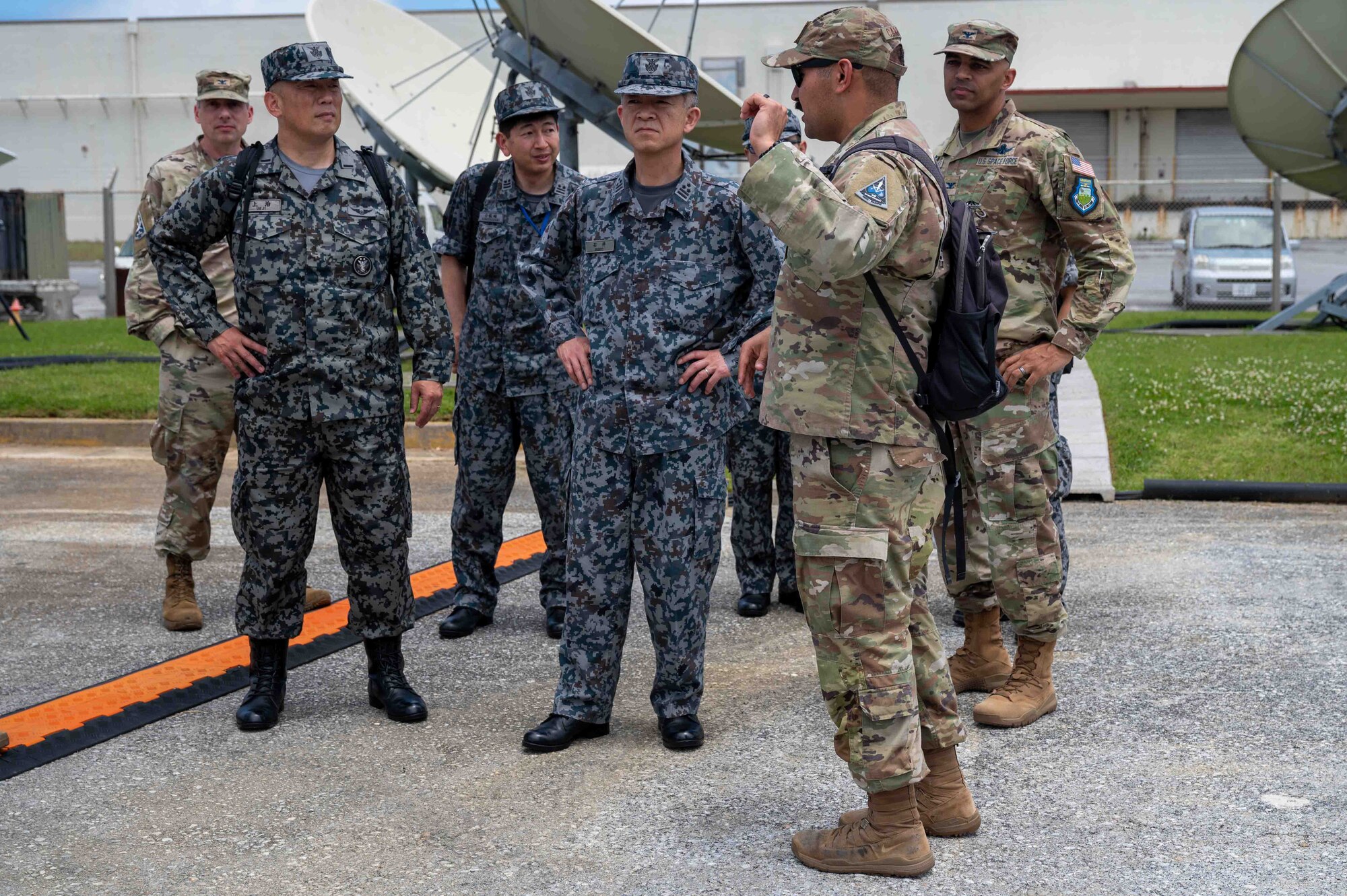Japanese service members tour the facility of space force service members.