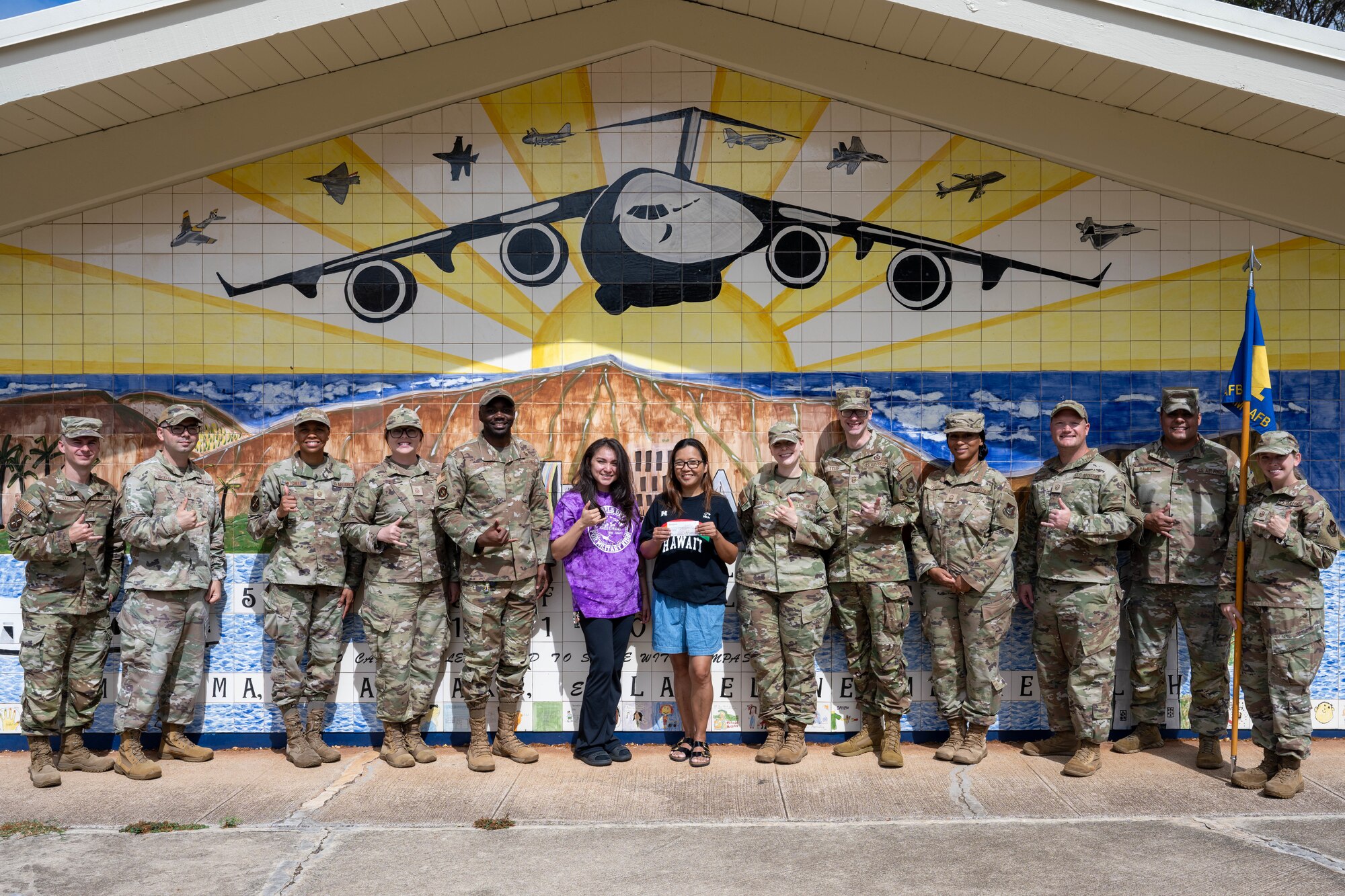 U.S. Air Force Airmen pose for a group photo with faculty at a elementary school on Joint Base Pearl Harbor-Hickam, Hawaii.