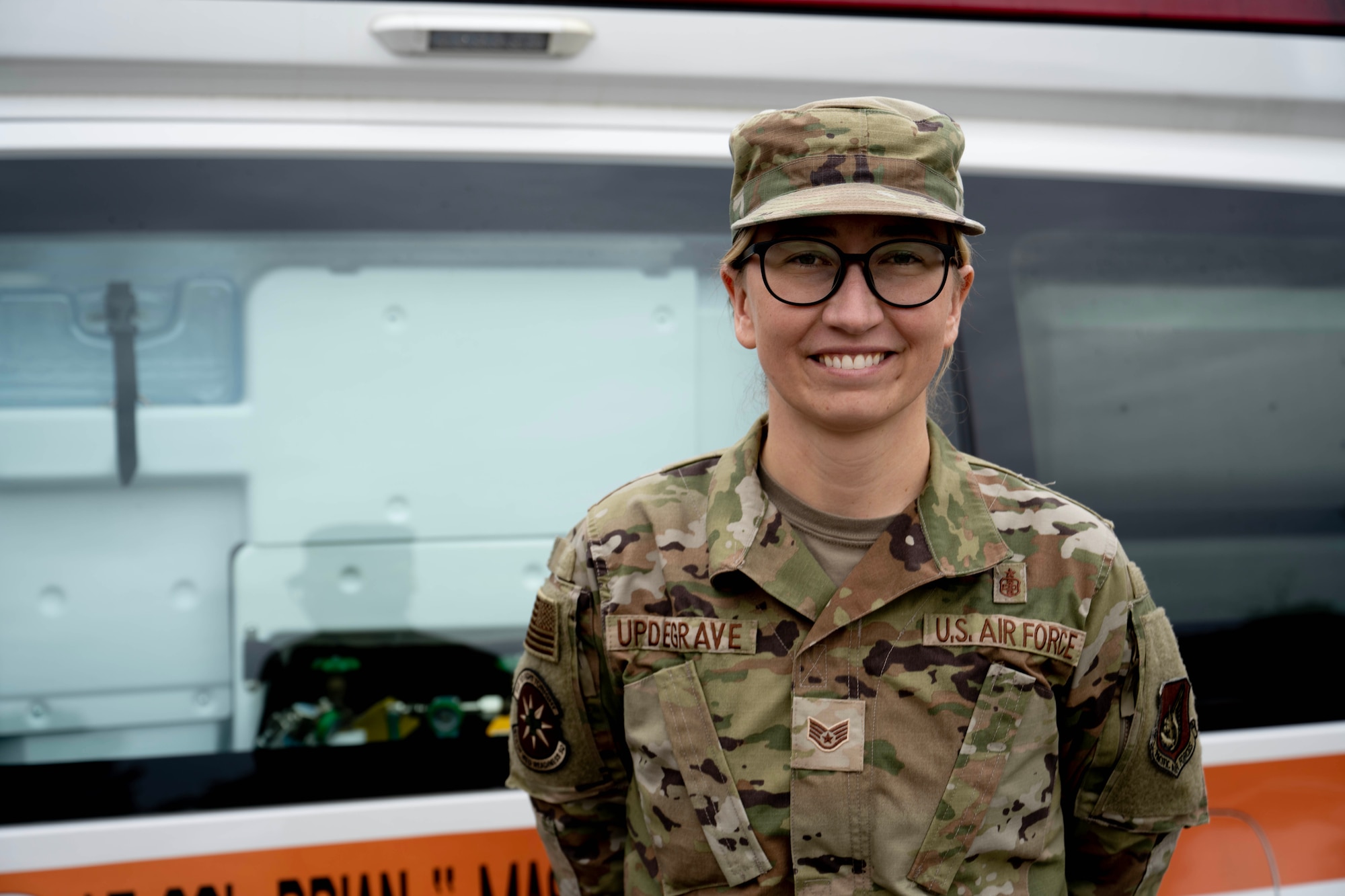 U.S. Air Force Staff Sgt. Wendy Updegrave, 8th Operational Medical Readiness Squadron noncommissioned officer in charge of the operational medicine cell, poses for a photo in front of an ambulance at Kunsan Air Base, Republic of Korea, June 13, 2025.