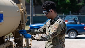 U.S. Air Force Senior Airman Ian Rodriguez, 51st Logistics Readiness Squadron fuels lab technician, takes a fuel sample at Osan Air Base, Republic of Korea, June 11, 2025. Rodriguez takes a sample of fuel to inspect, and ensure it is clean and clear of debris at the fuel machine filter separator. The Water and Fuel Expedient Repair System demonstration is the first training on Osan consisting of Airmen from both the 51st Civil Engineer Squadron and the 51st LRS. (U.S. Air Force photo by Senior Airman Rome Bowermaster)