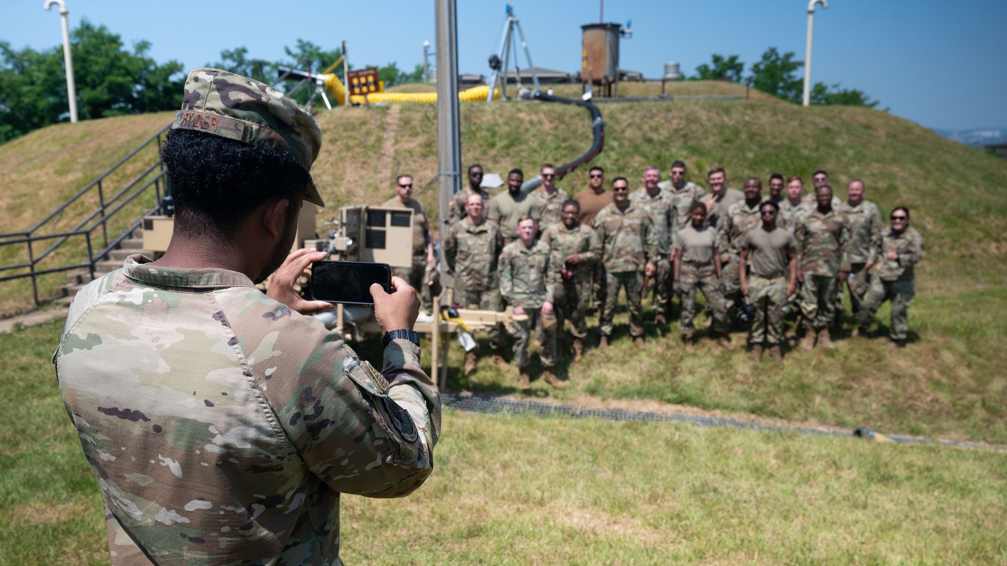 U.S. Air Force Airmen assigned to the 51st Civil Engineer Squadron and the 51st Logistics Readiness Squadron pose for a group photo at Osan Air Base, Republic of Korea, June 11, 2025. This marks the completion of phase one of the first Water and Fuel Expedient Repair System demonstration on base. The demonstration highlighted the base’s capability to expediently fill an R-11 refueler using the WaFERS system, showcasing Osan’s ability to rapidly restore fuel operations in a contingency environment. (U.S. Air Force photo by Senior Airman Rome Bowermaster)