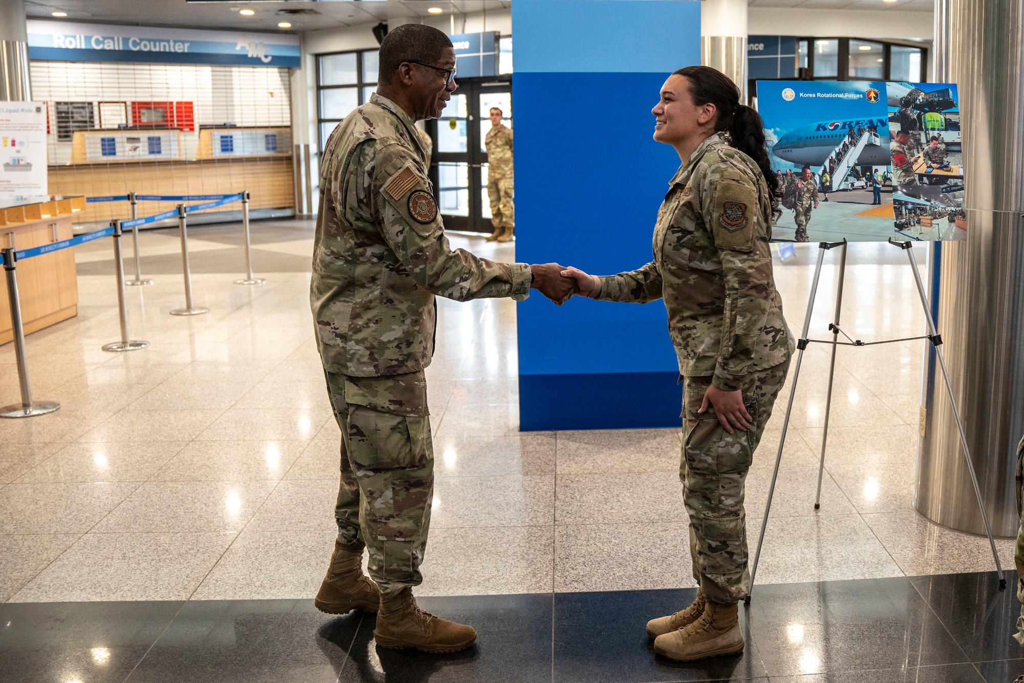 U.S. Air Force Tech. Sgt. Kayleen Saenz, 731st Air Mobility Squadron non-commissioned officer in charge of passenger service, receives a coin from Gen. Randall Reed, U.S. Transportation Command commander, during his visit to Osan Air Base, Republic of Korea, June 10, 2025.