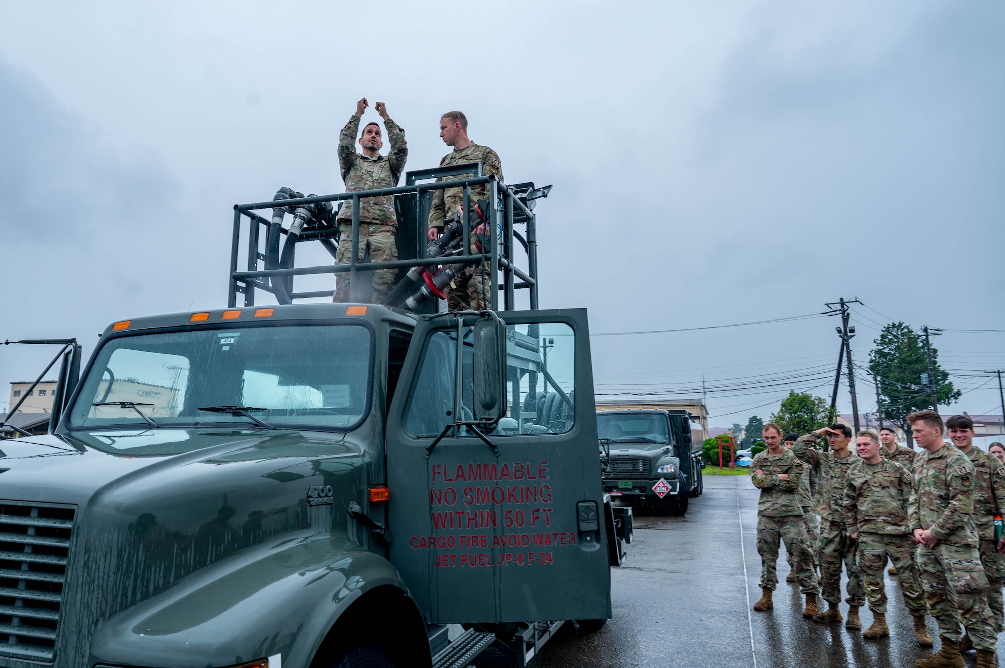 U.S. Air Force Airman 1st Class Andres Mercado Roman, 374th Logistics Readiness Squadron fuels distribution operator, left, shows U.S. Air Force Academy Cadet Dominick Lisitsin the capabilities of a petroleum, oil and lubricants vehicle.