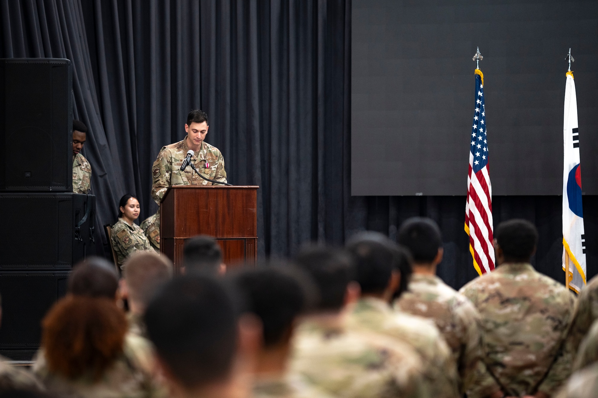 U.S. Air Force Maj. Clayton Sharum, outgoing 51st Comptroller Squadron commander, delivers farewell remarks during the 51st CPTS Change of Command ceremony at Osan Air Base, Republic of Korea, June 13, 2025.
