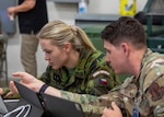 An Air National Guardsman and a Czech Republic military member collaborate together during exercise Cyber Shield 2025 in Virginia Beach, Virginia, June 9, 2025. Since 1993, the Czech Republic became a state partner of Texas and Nebraska through the National Guard State Partnership Program, and they have participated in multiple training exercises alongside both Army and Air National Guardsmen.