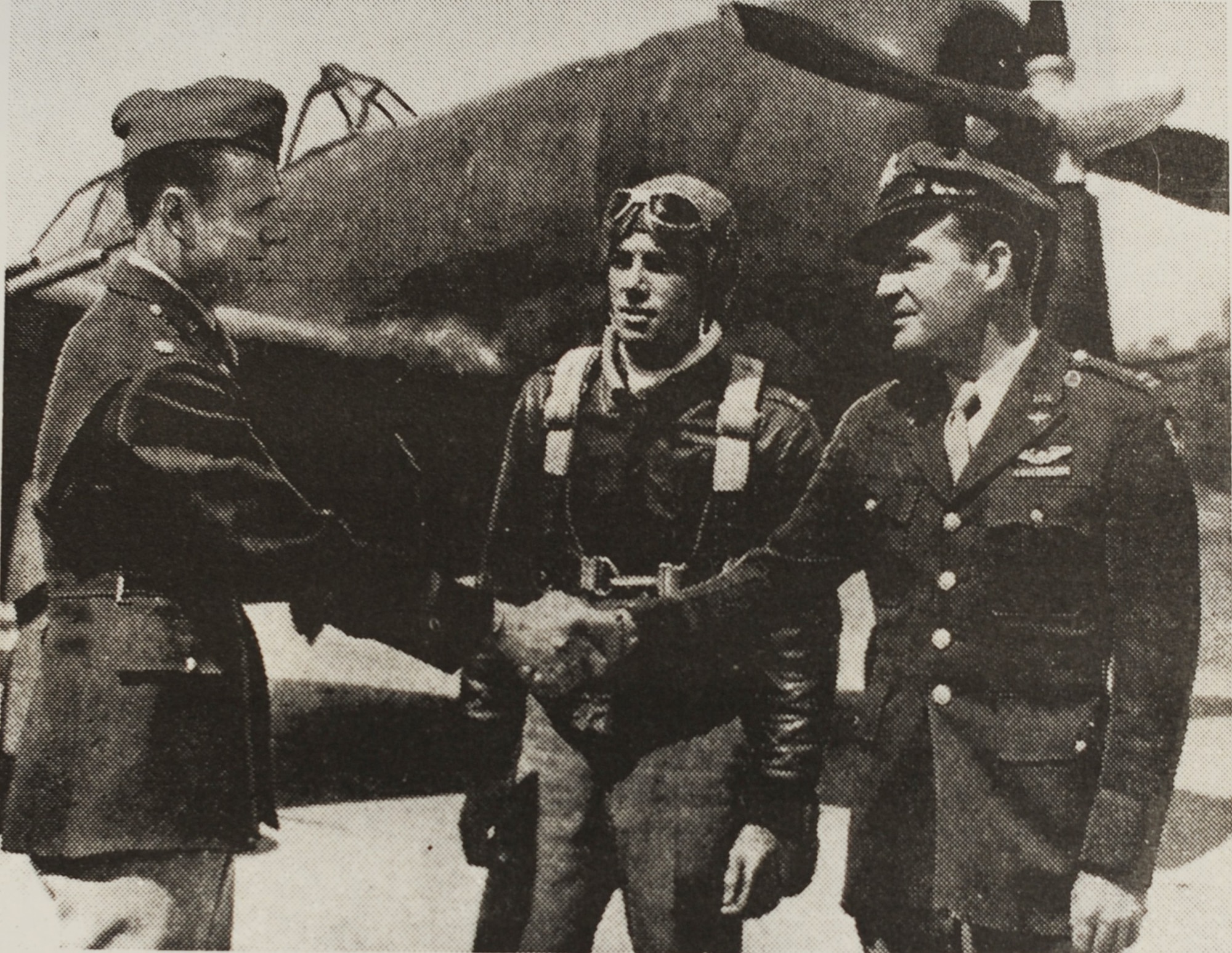 U.S. Army Maj. H.J. Nottingham (left) shakes hands with Capt. A.W. Salter, Jr. (right) as he takes over command of the airfield on May 2, 1943, at Camp Springs Army Airfield, Md. Behind them is a P-47 Thunderbolt – which was flown by Capt. D.A. Douglass (middle) -- that was the first aircraft to land at the airfield. (U.S. Army Photo)