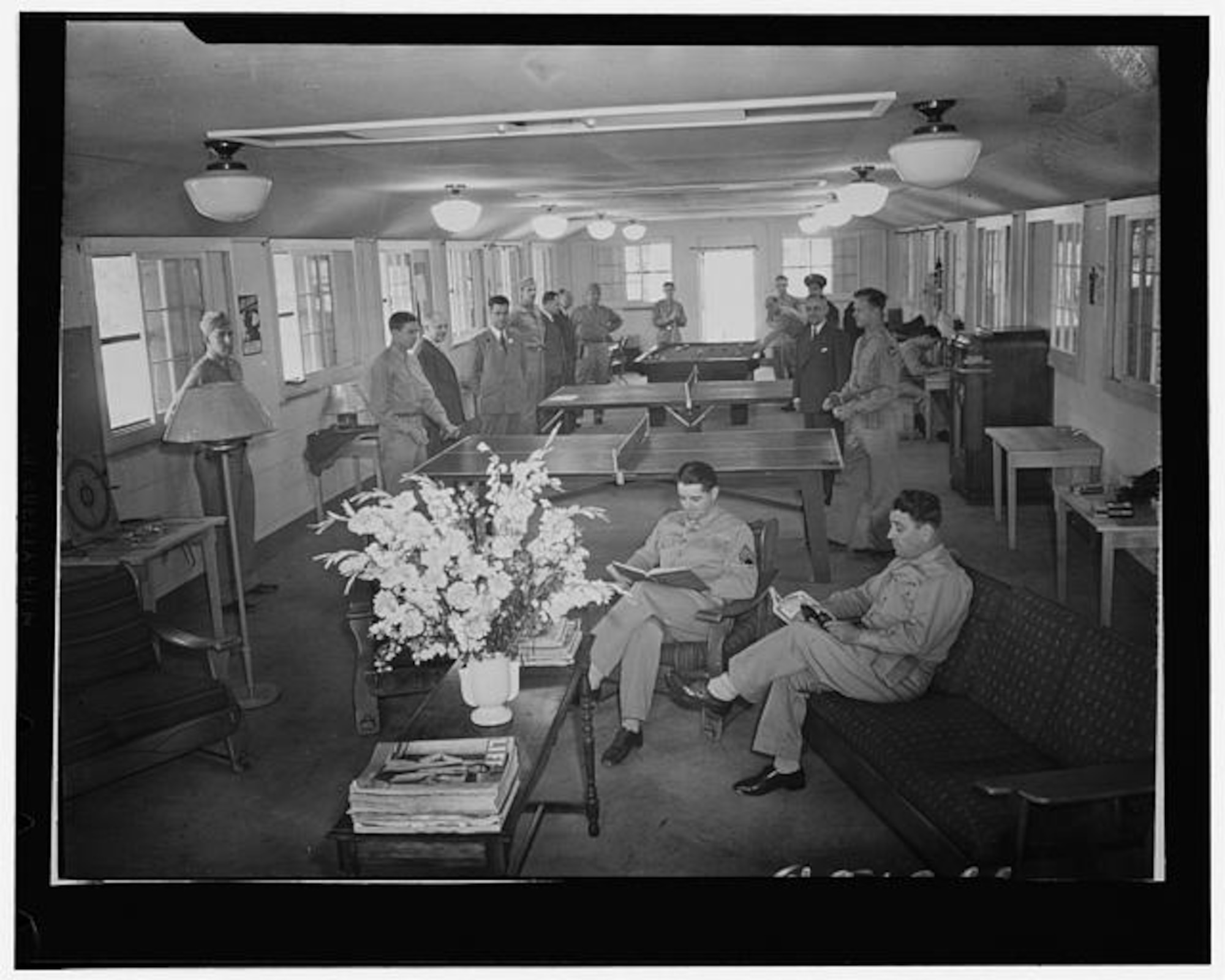 U.S. Army Soldiers relax in a day room in a dormitory at Camp Springs Army Airfield, Md., in 1943. (Farm Security Administration–Office of War Information photograph collection, Library of Congress Photo)