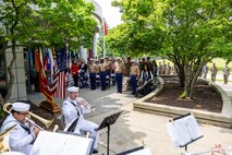 U.S. Marines with 9th Marine Corps District stand at attention for the playing of anchors’ aweigh during a post and relief ceremony at the 9th Marine Corps District Headquarters on Naval Station Great Lakes, Illinois, June 12, 2025. The ceremony  was held to mark the transition between senior enlisted leadership, signifying all responsibilities and authorities being transferred between the sergeants major. During the ceremony, Leader relinquished his post, and Sgt. Maj. Cory Curtis assumed his duties as the command’s senior enlisted leader. (U.S. Marine Corps photo by Cpl. Maxwell Cook)