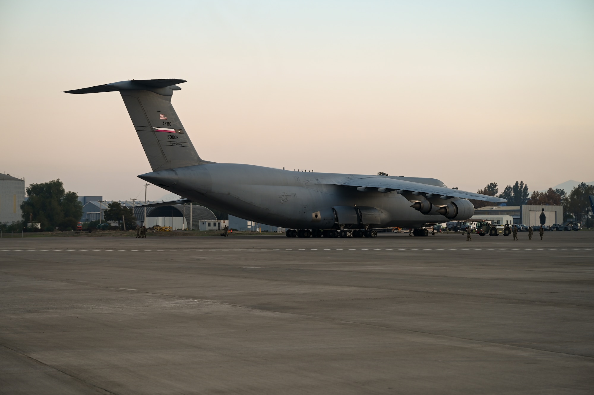 433rd Airlift Wing maintainers tow a C-5M Super Galaxy back into its parking spot following a sortie supporting Air Force Special Operations Command and partner nation special forces as part of Exercise Southern Star ‘25 at Arturo Merino Benitez International Airport in Santiago, Chile, June 4, 2025.