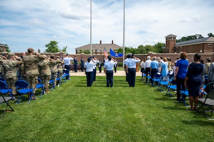 U.S. Airmen and members of the audience stand for the playing of “The Star-Spangled Banner” during the 794th Communications Squadron change of command ceremony at Joint Base Anacostia-Bolling, Washington, D.C., June 10, 2025. During the command of U.S. Air Force Lt. Col. Daniel P. Boyarski, the 794th CS provided individual and unit customer support, information technology service management functions and improvements to joint basing information enterprise service functions. (U.S. Air Force photo by Hayden Hallman)