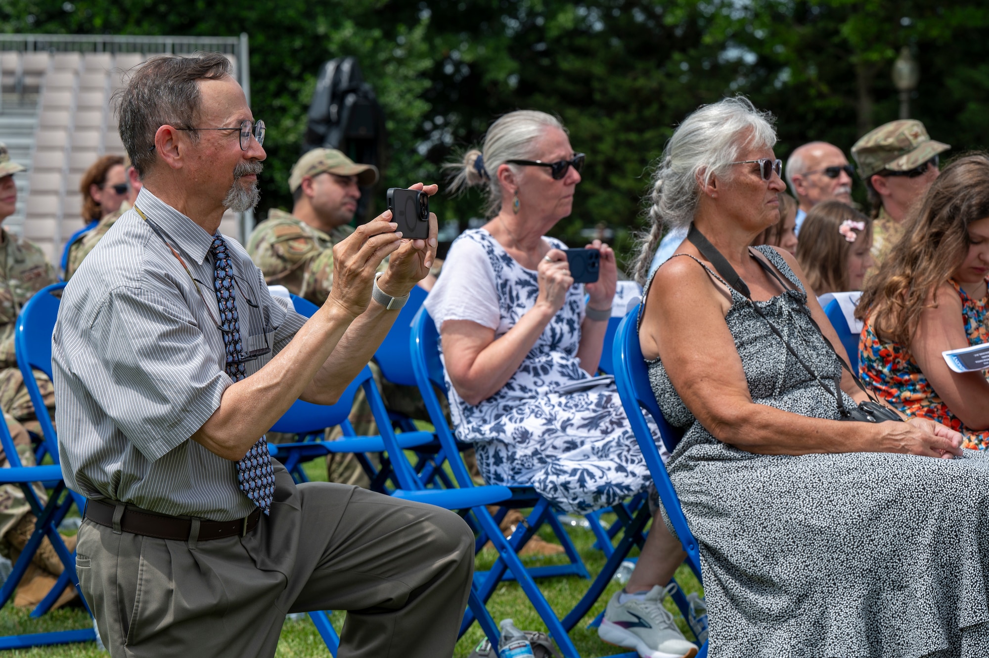 Retired U.S. Air Force Lt. Col. David P. Boyarski and Jane Boyarski record their son, Lt. Col. Daniel P. Boyarski, 794th Communications Squadron outgoing commander, during the 794th CS change of command ceremony at Joint Base Anacostia-Bolling, Washington, D.C., June 10, 2025. During Boyarski’s command, the 794th CS led the way for multiple upgrades and renovations to JBAB’s communications infrastructure to ensure the continuation and modernization of critical IT support. (U.S. Air Force photo by Hayden Hallman)