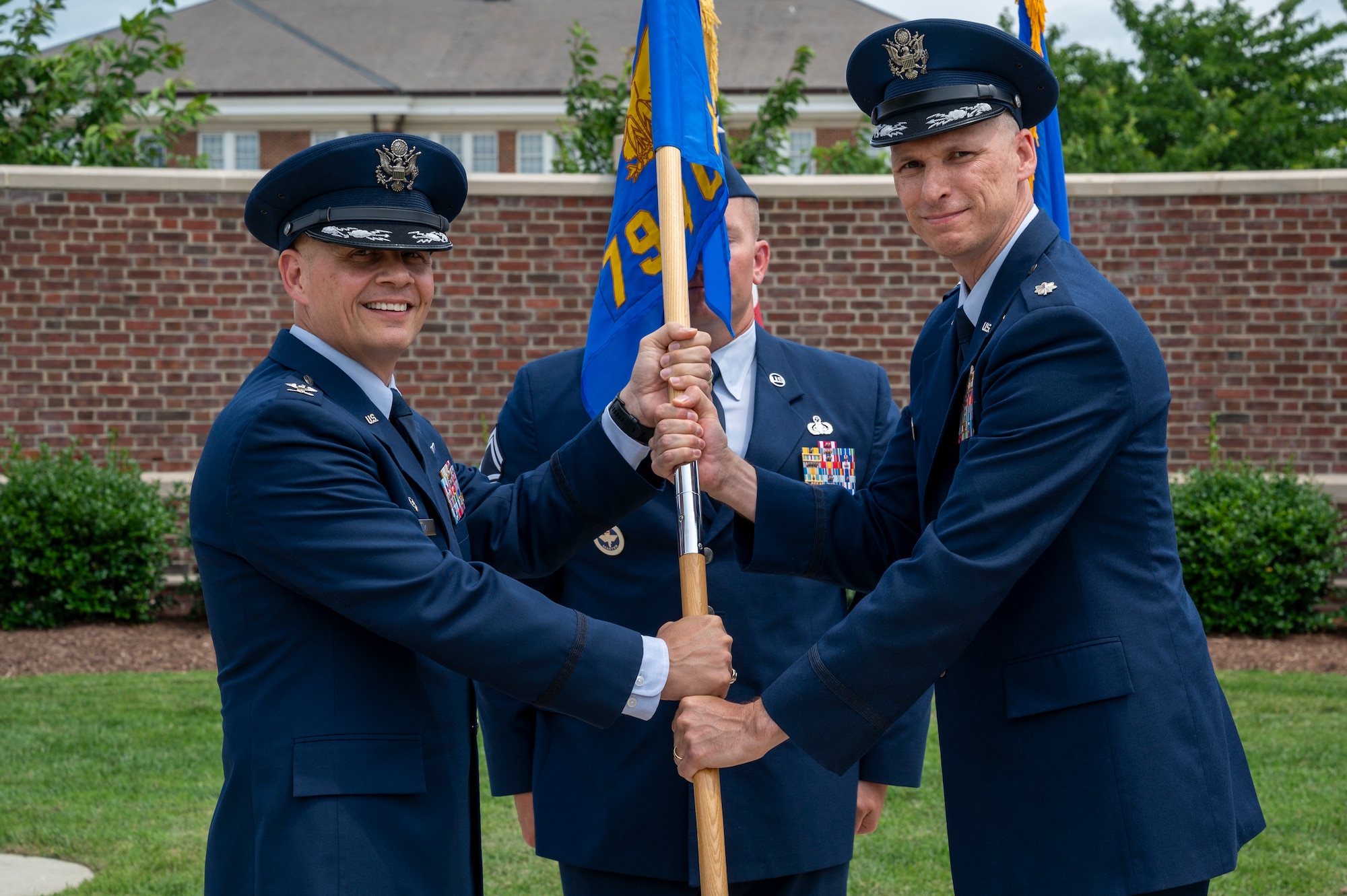 From left, U.S. Air Force Col. Patrick D. Rienzi, 844th Communications Group commander, bestows the guidon upon Lt. Col. Jeffrey P. Pelkey, 794th Communications Squadron incoming commander, during the 794th CS change of command ceremony at Joint Base Anacostia-Bolling, Washington, D.C., June 10, 2025. Pelkey previously served as the branch chief of 17D Talent Management, Headquarters Air Force at the Pentagon. (U.S. Air Force photo by Hayden Hallman)