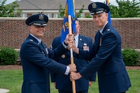 From left, U.S. Air Force Col. Patrick D. Rienzi, 844th Communications Group commander, bestows the guidon upon Lt. Col. Jeffrey P. Pelkey, 794th Communications Squadron incoming commander, during the 794th CS change of command ceremony at Joint Base Anacostia-Bolling, Washington, D.C., June 10, 2025. Pelkey previously served as the branch chief of 17D Talent Management, Headquarters Air Force at the Pentagon. (U.S. Air Force photo by Hayden Hallman)
