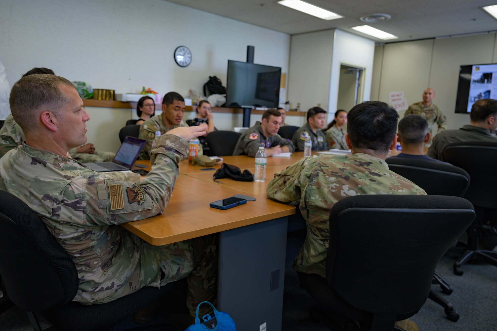 Language Enabled Airman Program participants engage in discussion during the Agile Combat Employment brief at Yokota Air Base, Japan, May 15th 2025. As the Air Force continues to build regional partnerships, LEAP ensures Airmen are mission-ready, culturally aware and capable of leading in diverse operational environments. (U.S. Air Force photo by Staff Sgt. Manuel G. Zamora)