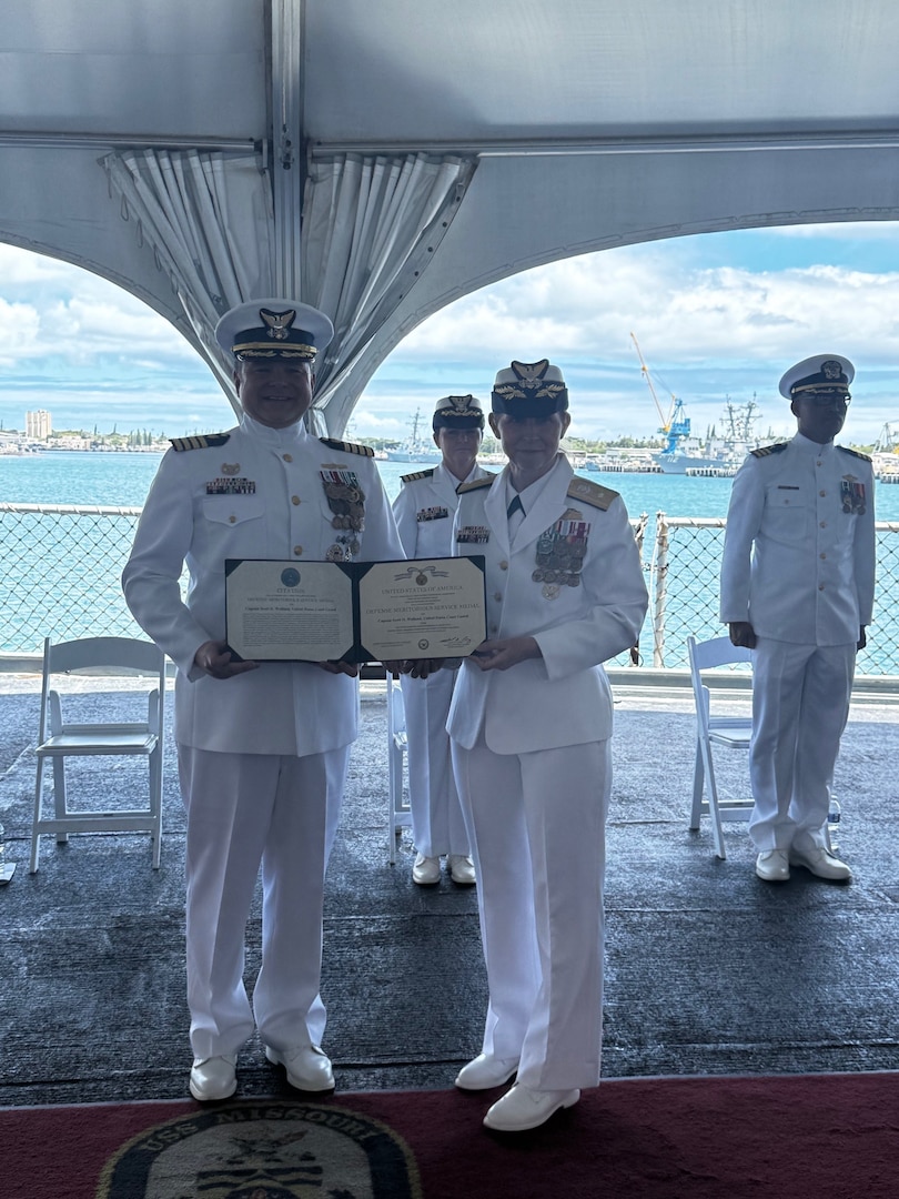 Rear Adm. Hiigel, deputy commander for Coast Guard Pacific Area, presented an award to Capt. Scott Wolland during the change of command ceremony for U.S. Coast Guard Reserve Unit at the United States Indo-Pacific Command (CGRU USINDOPACOM), June 12, 2025, in Honolulu. CGRU USINDOPACOM is a unique joint unit, in which members are integrated throughout the U.S. Indo-Pacific combatant command, providing leadership, expertise, and support to the joint force. (U.S. Coast Guard courtesy photo)
