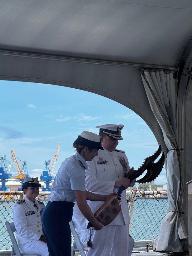 Capt. Scott Wolland, commanding officer of U.S. Coast Guard Reserve Unit at the United States Indo-Pacific Command (CGRU USINDOPACOM), received a departure gift from the crew during the change of command ceremony, June 12, 2025, in Honolulu. CGRU USINDOPACOM is a unique joint unit, in which members are integrated throughout the U.S. Indo-Pacific combatant command, providing leadership, expertise, and support to the joint force. (U.S. Coast Guard courtesy photo)