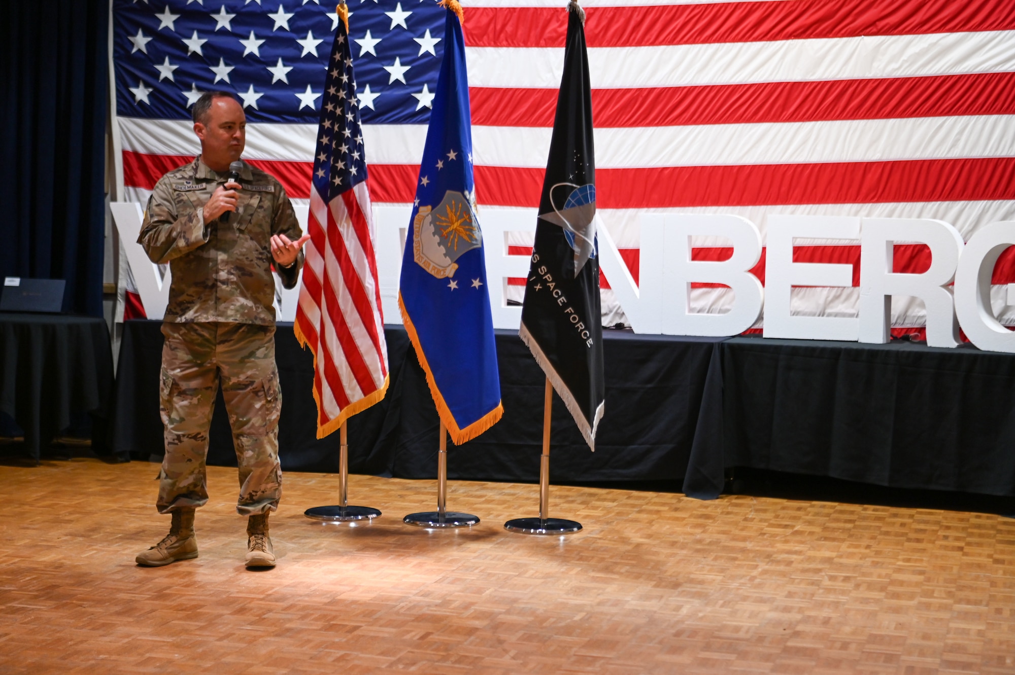 A person stands on a stage inside