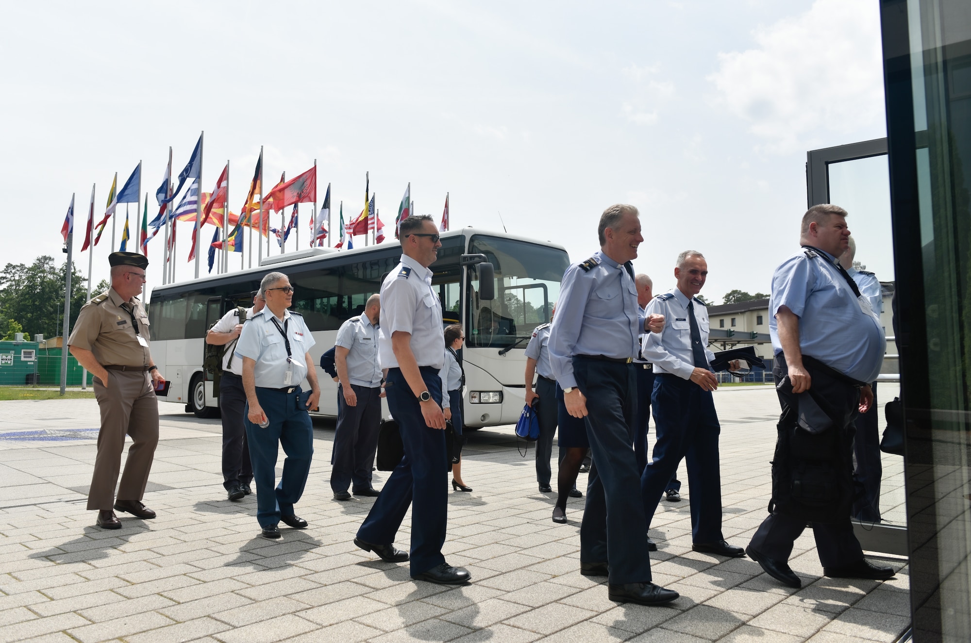 Attendees of the NATO Air Force Chaplains Consultative Committee Conference arrive at Allied Air Command headquarters, Ramstein Air Base, Germany, June 10, 2025. Military chaplains from 12 NATO and partner nations across Europe convened at Ramstein for a conference to wargame how they might operate together in future conflicts. (U.S. Air Force photo by Capt. Cameron Silver)