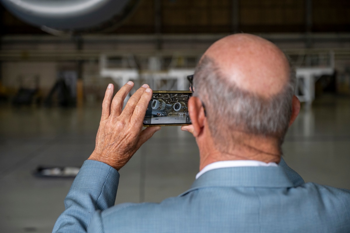A member of the Defense Orientation Conference Association captures a photo of a C-17 Globemaster III at Joint Base Lewis-McChord, Washington, June 11, 2025.