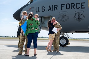 military hugging family after returning home from a deployment
