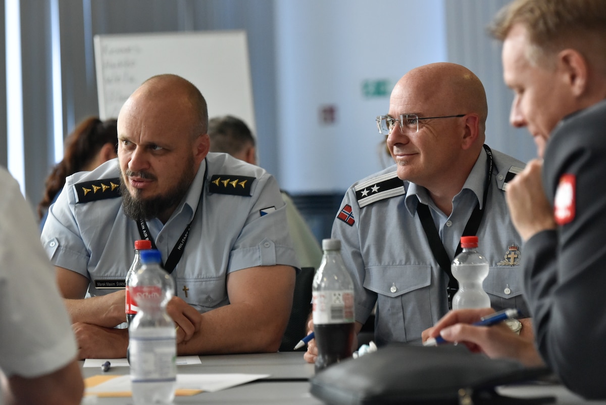 Chaplain (Capt.) Marekmaxim Svancara, a chaplain in the Czech Air Force, left, Chaplain (Lt. Col.) Tore Meberg-Hansen, Chief of Chaplains for the Royal Norwegian Air Force, center, and Chaplain (Col.) Grzegorz Przewrocki, a chaplain in the Polish Air Force, participate in a tabletop exercise at the NATO Air Force Chaplains Consultative Committee Conference, Ramstein Air Base, Germany, June 10, 2025. Military chaplains from 12 NATO and partner nations across Europe convened at Ramstein for a conference to wargame how they might operate together in future conflicts. (U.S. Air Force photo by Capt. Cameron Silver)
