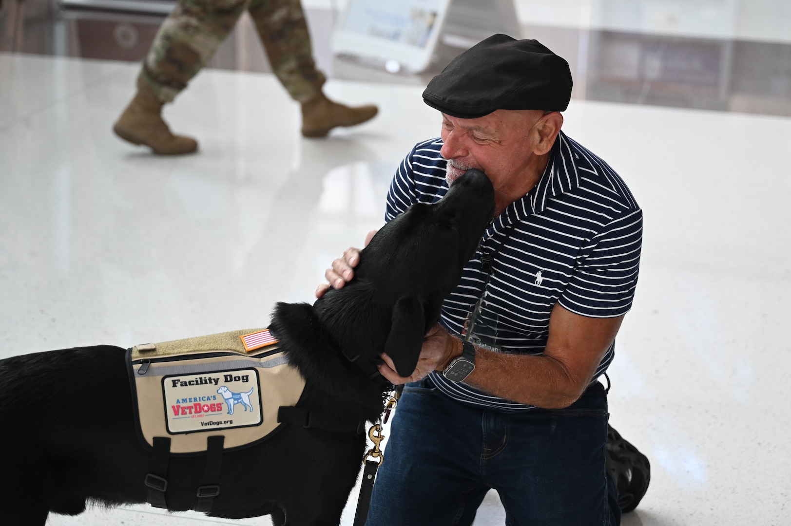 Photo of CRDAMC's Facility Dog Solomon interacting with employee
