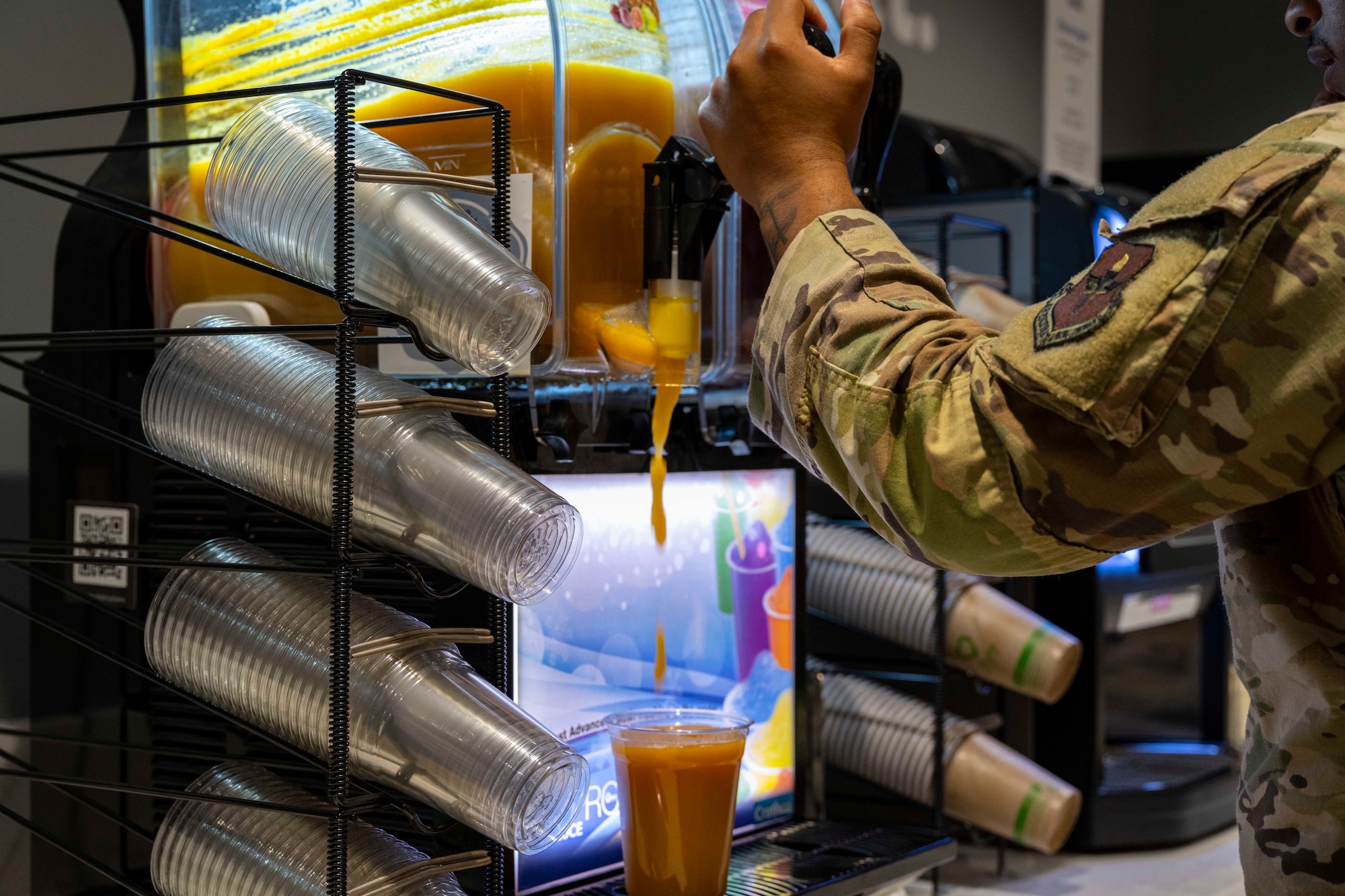 A member of the 49th Wing fills a cup with a smoothie during the Shifting Sands Dining Facility grand reopening ceremony at Holloman Air Force Base, New Mexico, June 12, 2025.