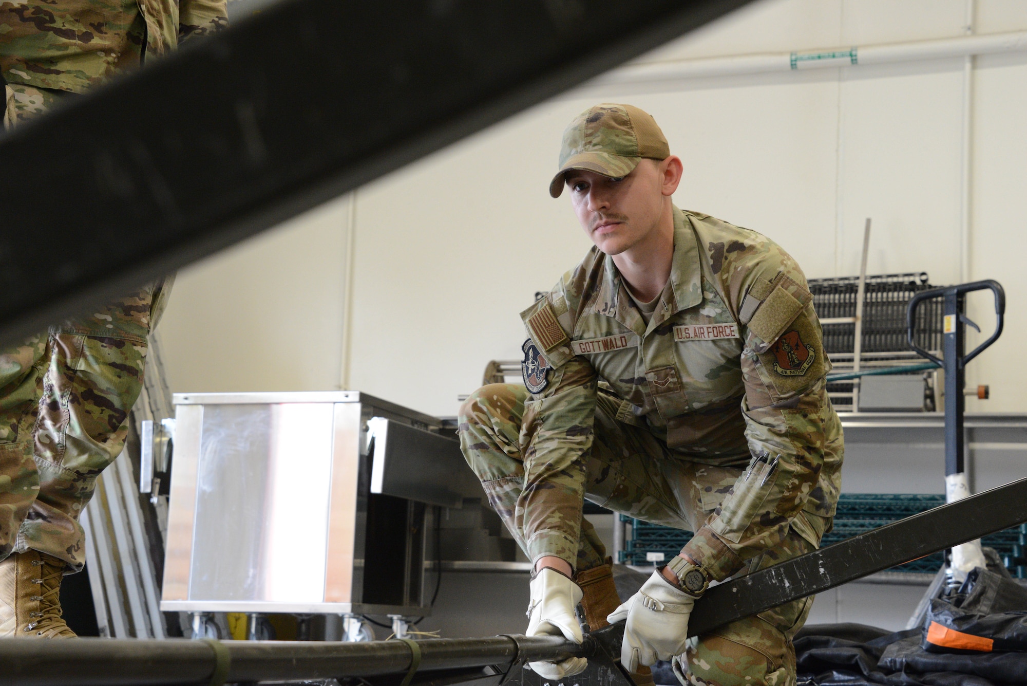 Airman 1st Class Steven Gottwald, a 185th Force Support Squadron personnel specialist, holds the structure of a temporary tent in place