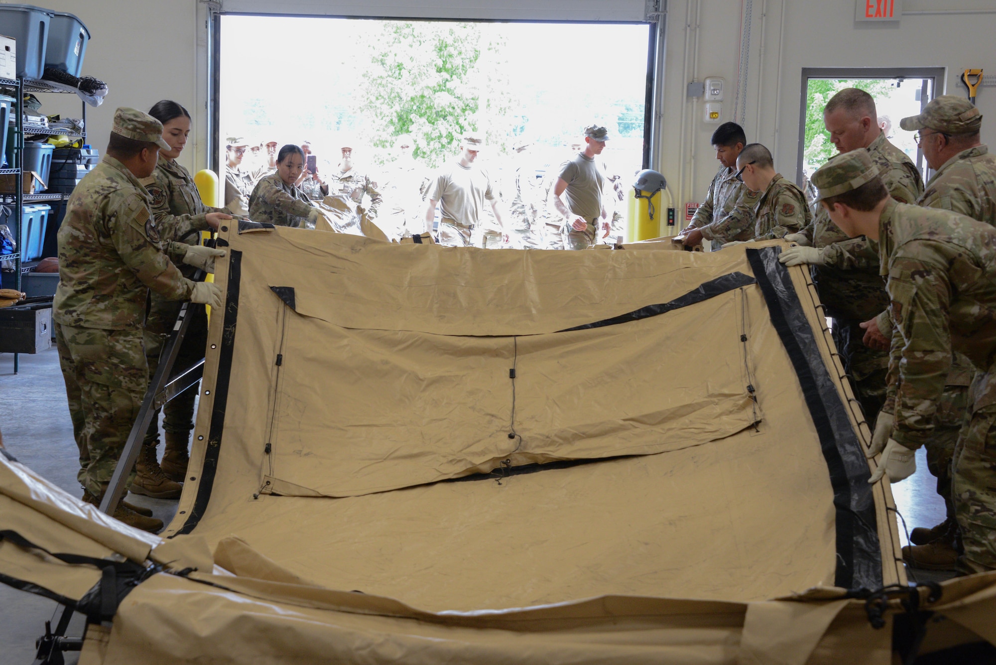 irmen of the 185th Force Support Squadron work together to build a temporary tent