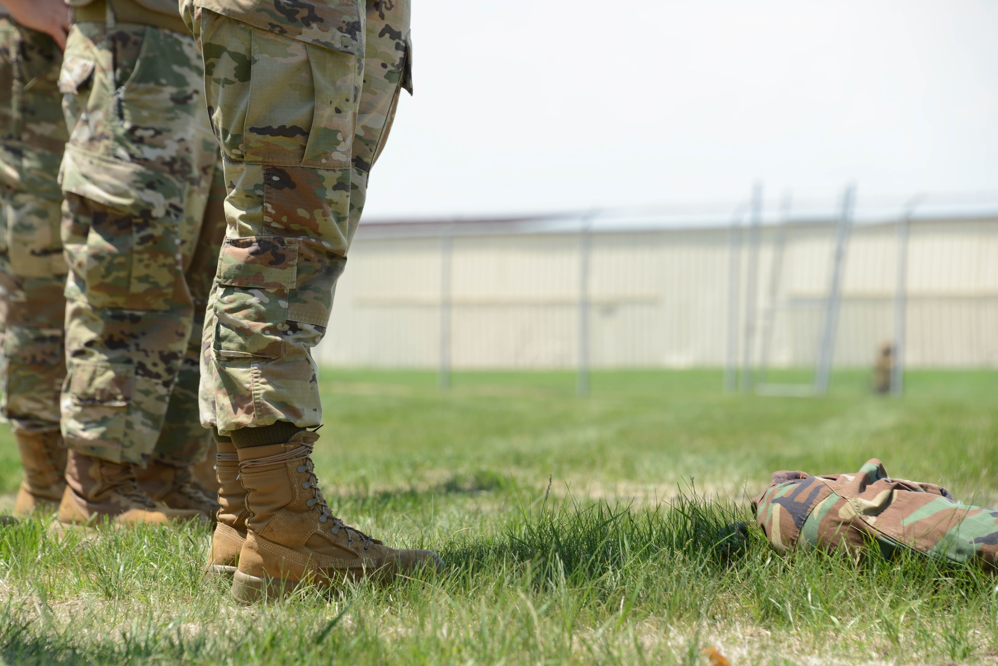 Airman of the 185th Force Support Squadron stands over a simulated limb