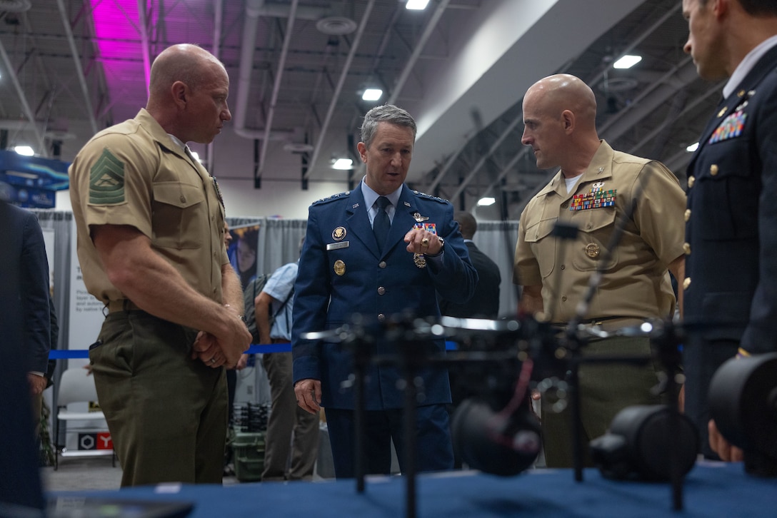 U.S. Air Force Gen. Dan Caine, Chairman of the Joint Chiefs of Staff, speaks to Marines of the Marine Corps Attack Drone Team about the Neros Archer drone during the AI+ Expo in Washington D.C., June 4, 2025. The AI+ Expo serves as a forum for industry, government, and academic research entities to exhibit some of the latest technological breakthroughs - in AI, biotech, energy, networks, compute, microelectronics, manufacturing, augmented reality, and beyond - and discuss their implications for U.S. and allied competitiveness. (U.S. Marine Corps photo by Sgt. Matthew Romonoyske-Bean)