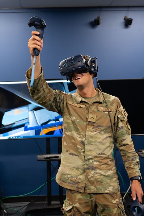 U.S. Air Force Cadet Huck Patton uses a VR headset during the Information Technology Unit flight immersion at the 17th Training Support Squadron, Goodfellow Air Force Base, Texas, June 4, 2025. Patton was in an aircraft simulation application that aims to familiarize users with different aircrafts that they do not have access to on their installation. (U.S. Air Force photo by Airman 1st Class Brian Lummus)