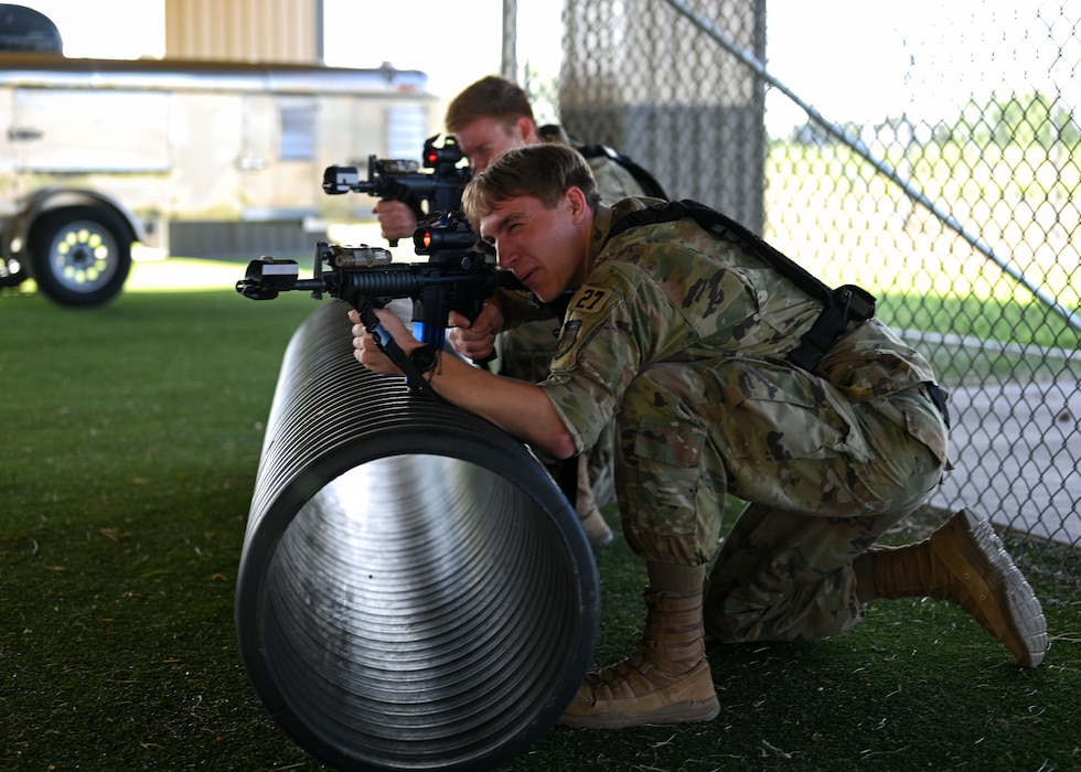 U.S. Air Force Academy cadets practice small unit tactics during the OPS Air Force Goodfellow Air Force Base visit at the 17th Security Forces Squadron kennels, Goodfellow AFB, Texas, June 9, 2025. Small unit movements for security forces involve tactics and techniques employed by small units, like platoons or squads, to move through an area while maintaining security.  (U.S. Air Force Senior Airman Evelyn J. D’Errico)