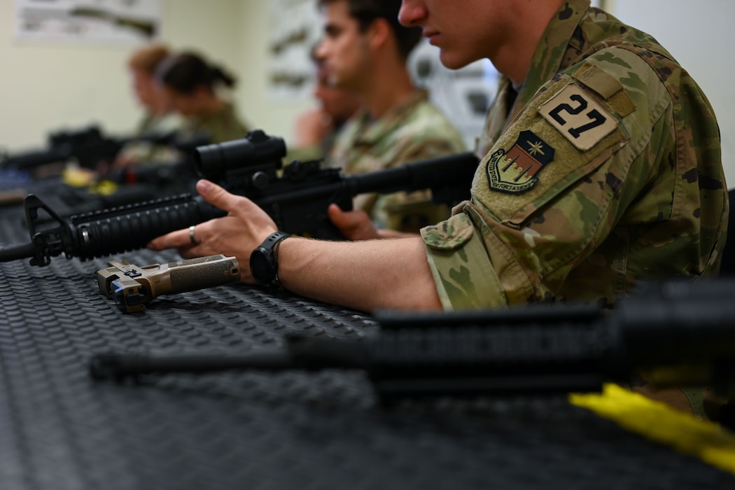 U.S. Air Force Academy cadets practice weapon clearing procedures during the OPS Air Force Goodfellow Air Force Base visit at the 17th Security Forces Squadron Combat Arms Training and Maintenance building, Goodfellow AFB, Texas, June 9, 2025. The cadets participated in a shortened Expeditionary Readiness Training course, Defender Challenge and a military working dog demonstration. (U.S. Air Force Senior Airman Evelyn J. D’Errico)