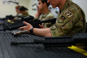 U.S. Air Force Academy cadets practice weapon clearing procedures during the OPS Air Force Goodfellow Air Force Base visit at the 17th Security Forces Squadron Combat Arms Training and Maintenance building, Goodfellow AFB, Texas, June 9, 2025. The cadets participated in a shortened Expeditionary Readiness Training course, Defender Challenge and a military working dog demonstration. (U.S. Air Force Senior Airman Evelyn J. D’Errico)