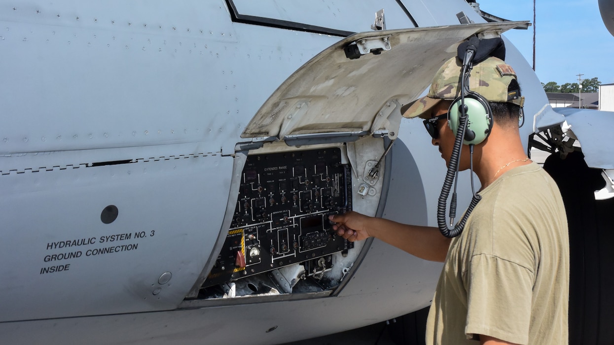 An airman checks aircraft prior to flight