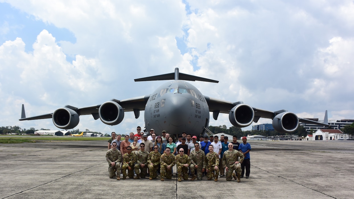 Group photo in front of aircraft