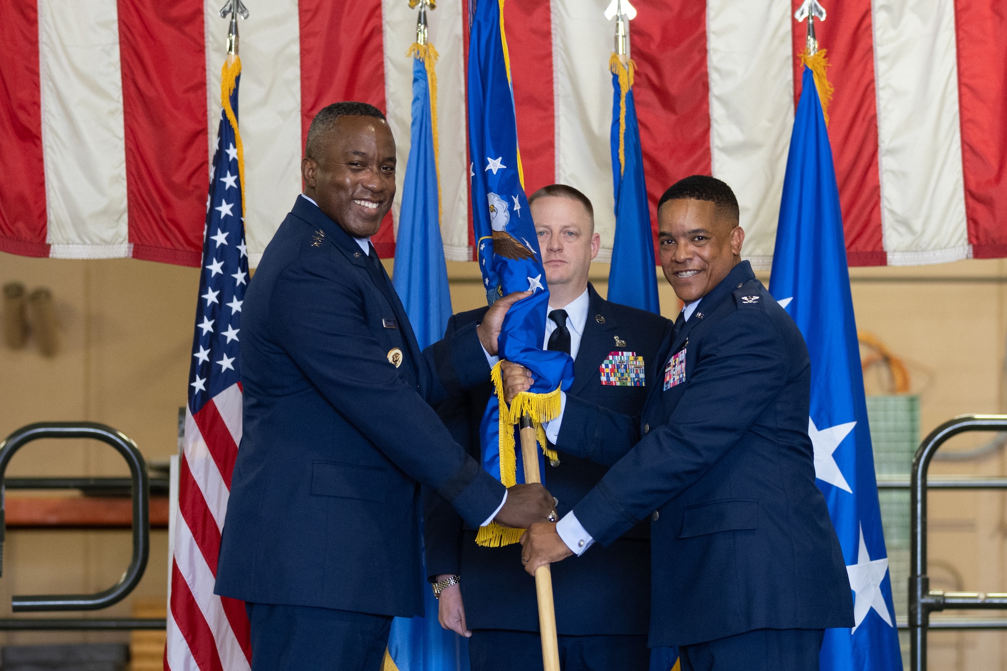 Two men holding flag.