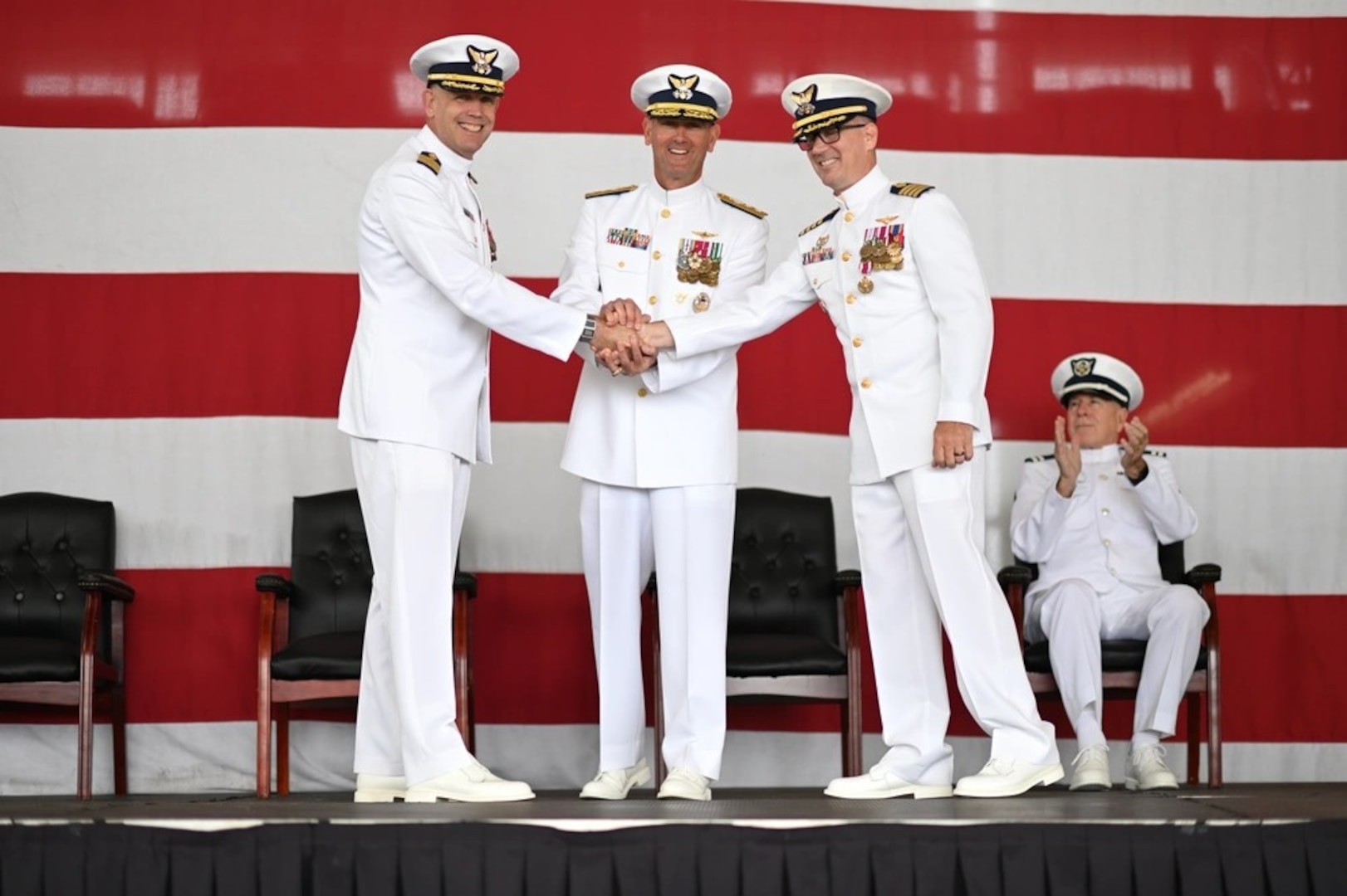 Capt. Robert Tucker relieves Capt. Patrick Dill as the Coast Guard Sector San Diego commander during a change of command ceremony in San Diego, June 13, 2025. Rear Adm. Joseph Buzzella, the 11th Coast Guard District commander, presided over the time-honored military tradition that represents a formal transfer of authority and responsibility for a unit from one commanding officer to another. (U.S. Coast Guard photo by Petty Officer 1st Class Adam Stanton)