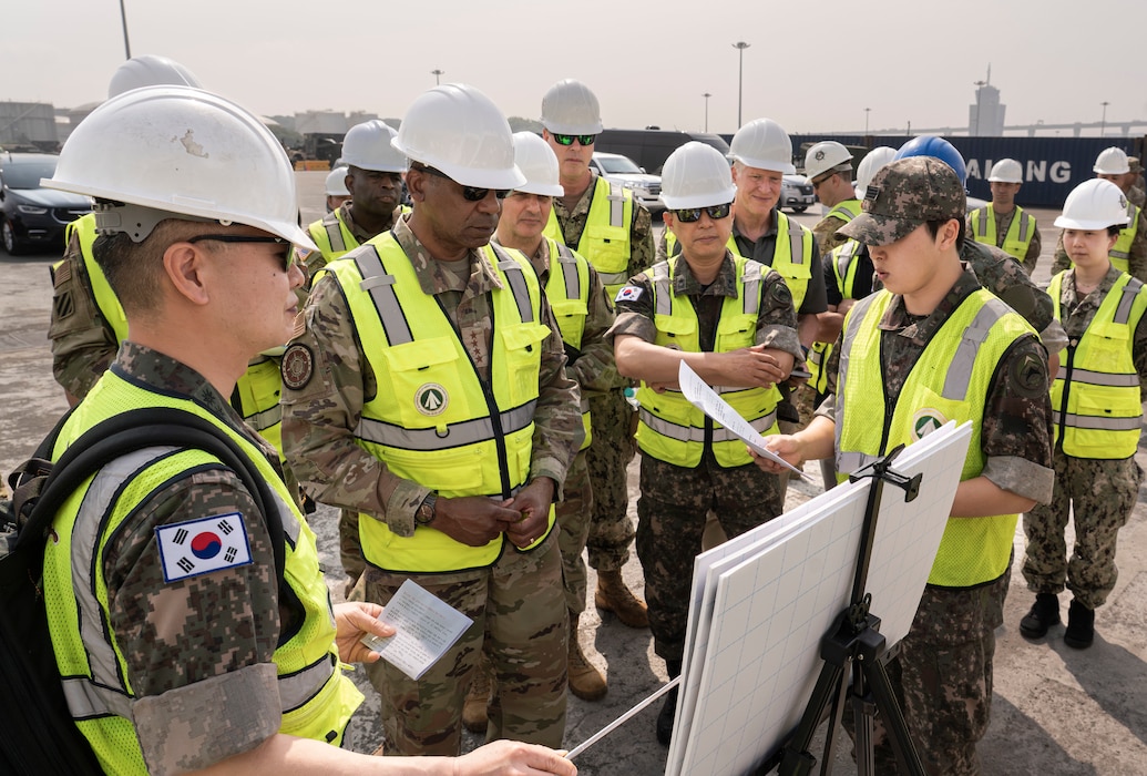 Air Force Gen. Randall Reed, commander of U.S. Transportation Command, receives a mission brief while touring Pyeongtaek Port, South Korea, June 10, 2025.